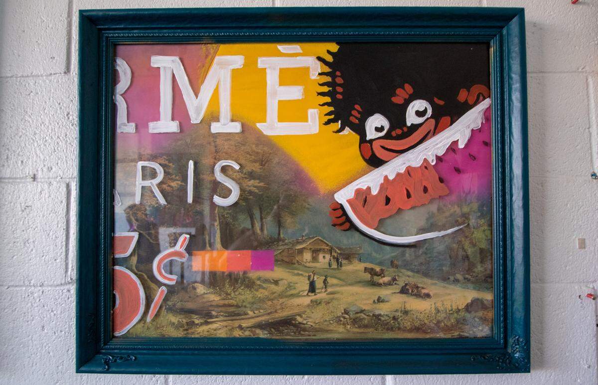 A brightly painted cartoon of a racial stereotype is overlayed on top of a slave scene in this work by Dammit Wesley.