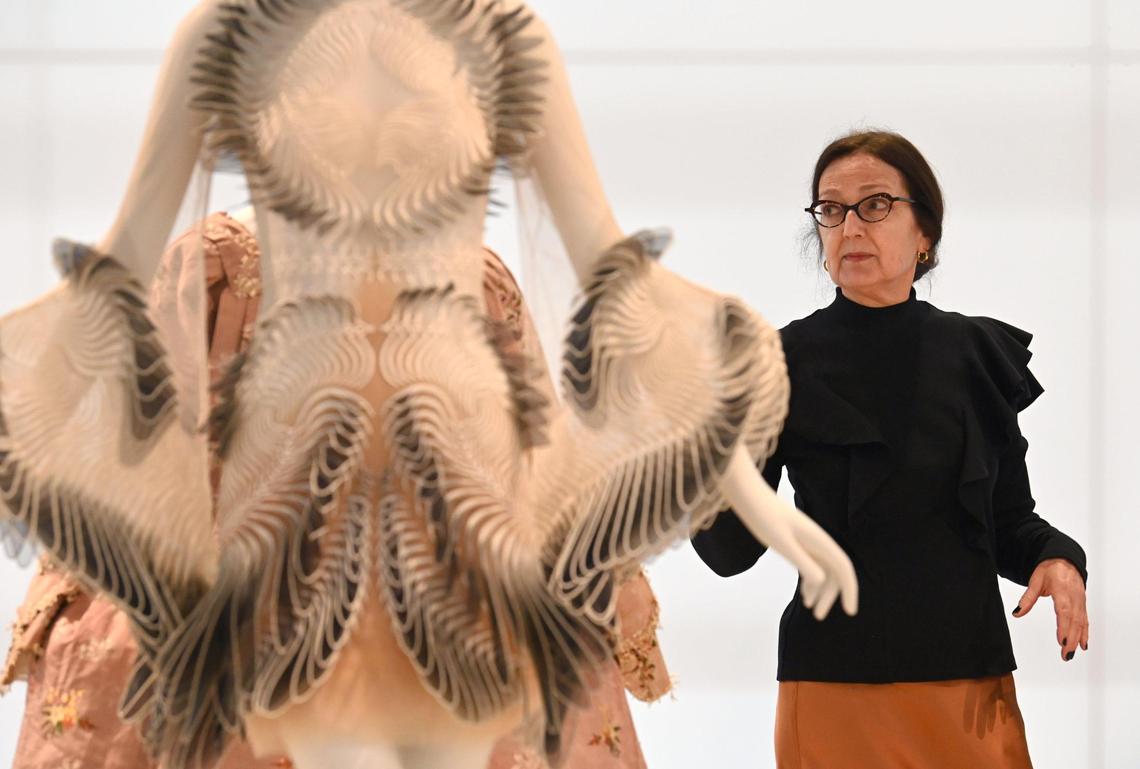 Annie Carlano, right, is the senior curator of craft, design and fashion at the Mint Museum. She spoke Friday, Dec. 9, at a media preview of the Fashion Reimagined exhibit.