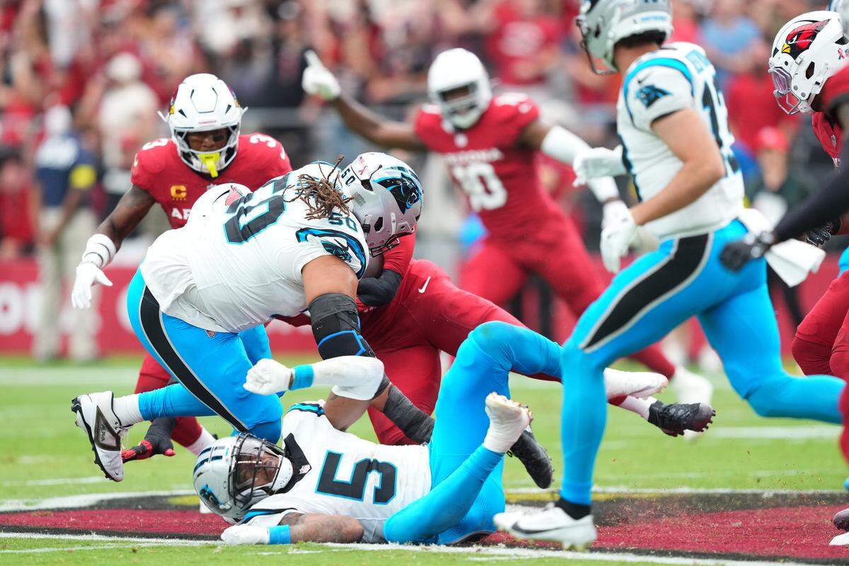 Carolina Panthers guard Robert Hunt (50) and running back Rico Dowdle (5) defend against the Arizona Cardinals during the first quarter at State Farm Stadium in Glendale, AZ on Sunday, Sept. 14, 2025.