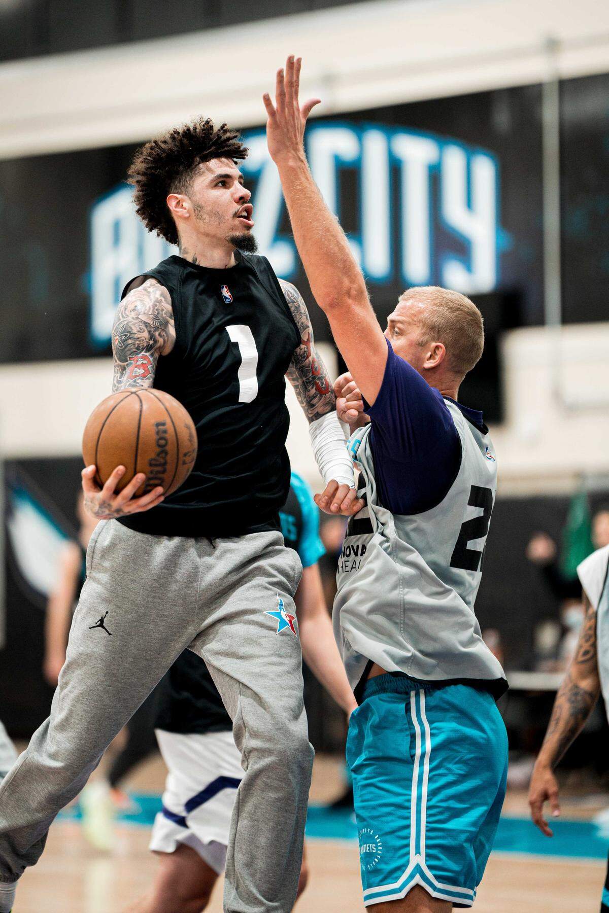 Charlotte Hornets center Mason Plumlee tries to block LaMelo Ball’s shot during practice on Wednesday, Oct. 8, 2025.