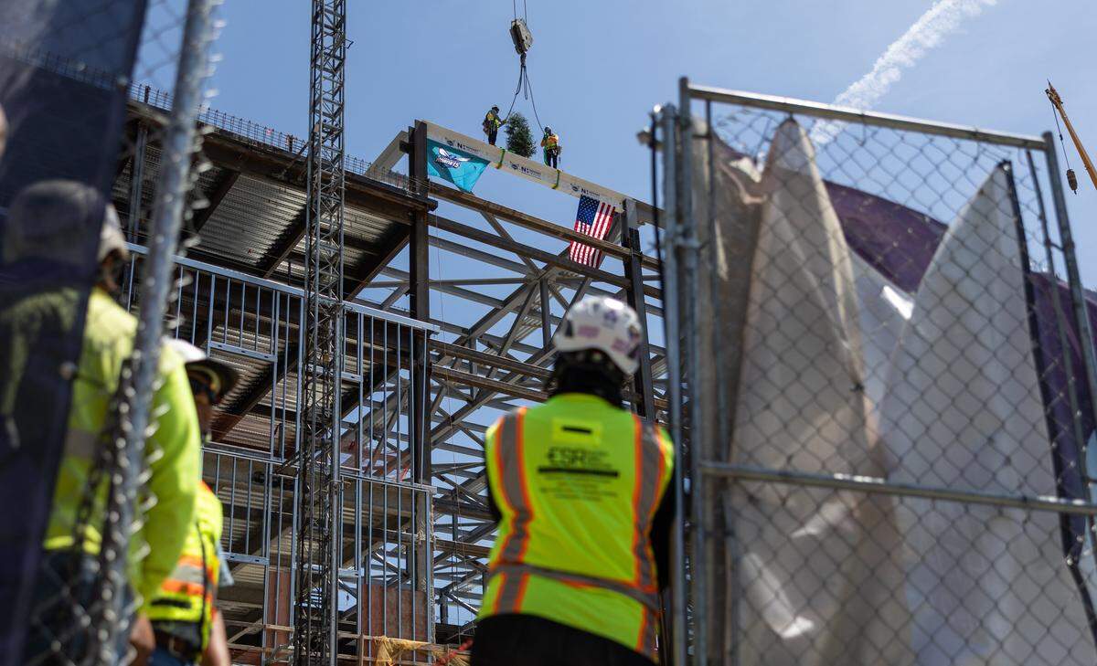 Construction workers raise the beam during the Hornets' ceremonial Topping Off Ceremony at Novant Health Performance Center's construction site, celebrating a major milestone, the placement of the building's final structural beam in Charlotte, N.C., on Monday, May 4, 2026.