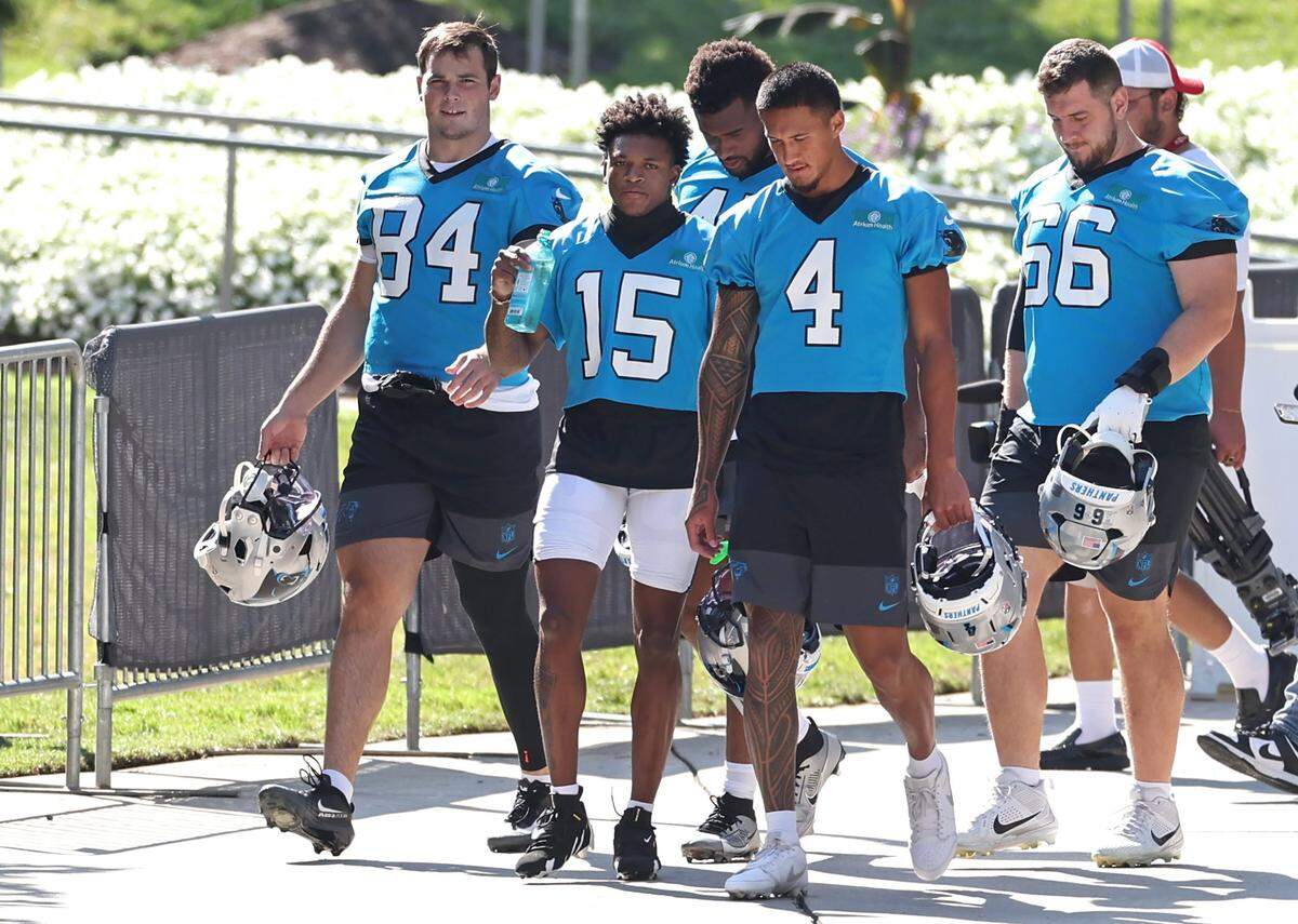 Members of the Carolina Panthers’ 2025 rookie class, including TE Mitchell Evans (left), WR Jimmy Horn Jr. (middle) and WR Tetairoa McMillan (right), walk to the team’s training camp practice on July 23, 2025.