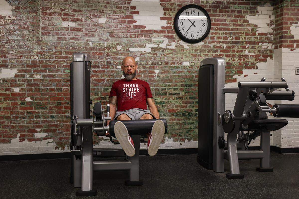 Donald Clark works on leg raises in one of the fitness areas of the Johnston Family YMCA in NoDa in early June.