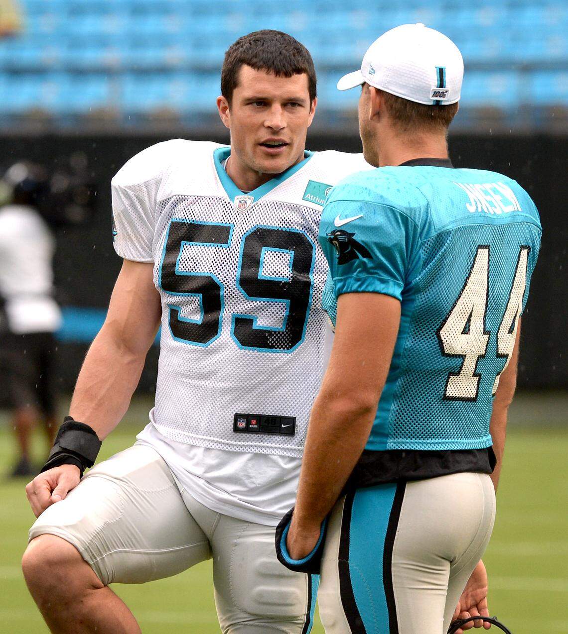 Carolina Panthers linebacker Luke Kuechly, left, talks with long snapper JJ Jansen, right, prior to the start of the team’s Fan Fest at Bank of America Stadium on Friday, August 2, 2019.