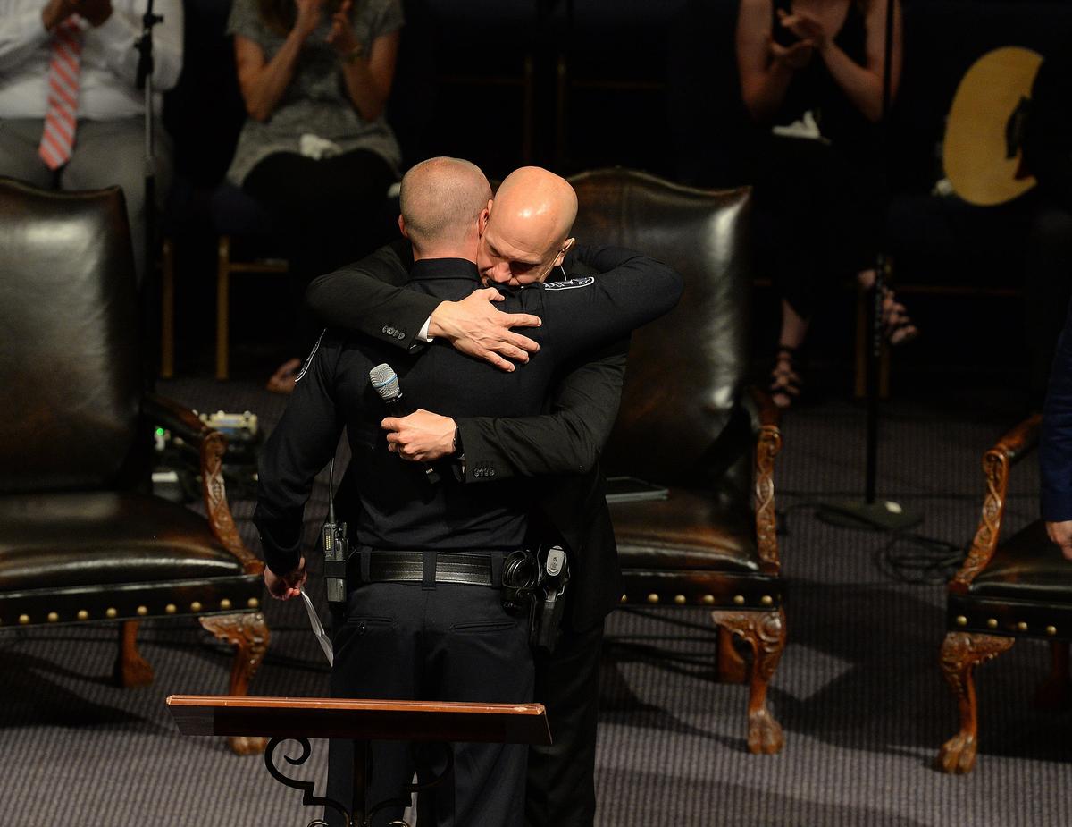 Katelyn Self’s fiancé, Alex Burns, left, is hugged by the family’s pastor, Austin Rammell, after talking about her at Sunday’s service. 