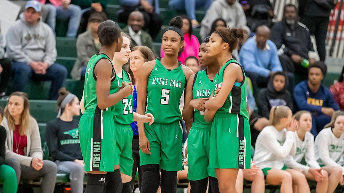 Myers Park starters gather at center court before the tipoff.
