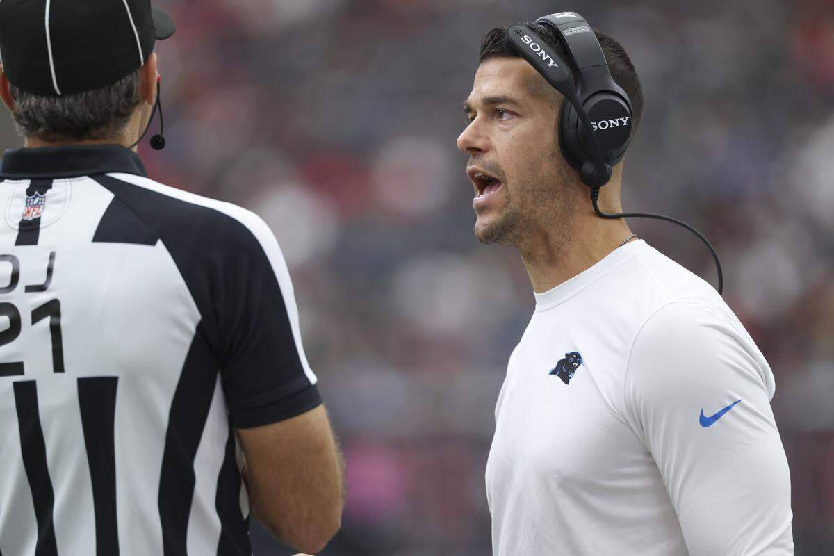 Aug 16, 2025; Houston, Texas, USA; Carolina Panthers head coach Dave Canales talks with an official during the first quarter against the Houston Texans at NRG Stadium. Mandatory Credit: Troy Taormina-Imagn Images