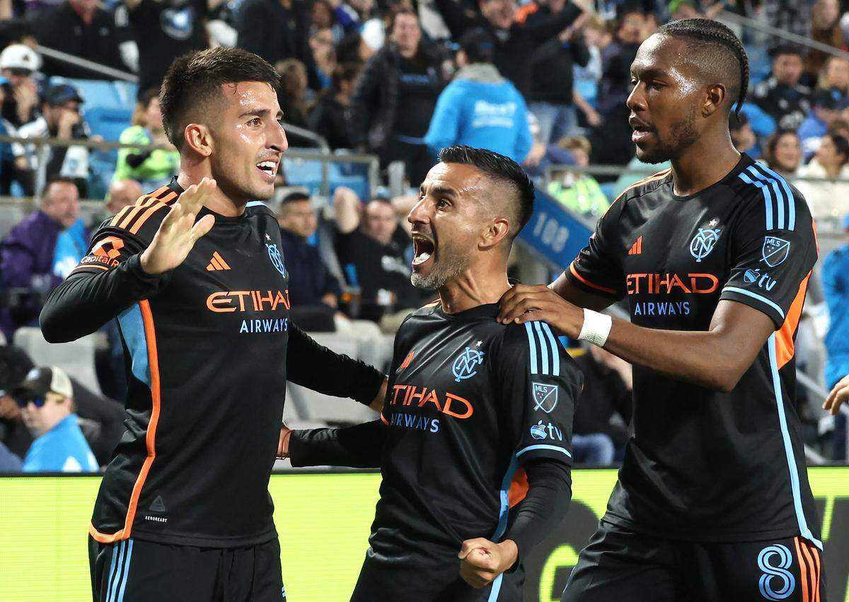 New York FC attacking midfielder Nicolas Fernandez, left, celebrates his goal with attacking midfielder Maxi Moralez, center and defensive midfielder Andres Perea, right, following Fernandez's goal against Charlotte FC during Game 3 of the MLS Playoffs at Bank of America Stadium in Charlotte, NC on Friday, November 7, 2025.