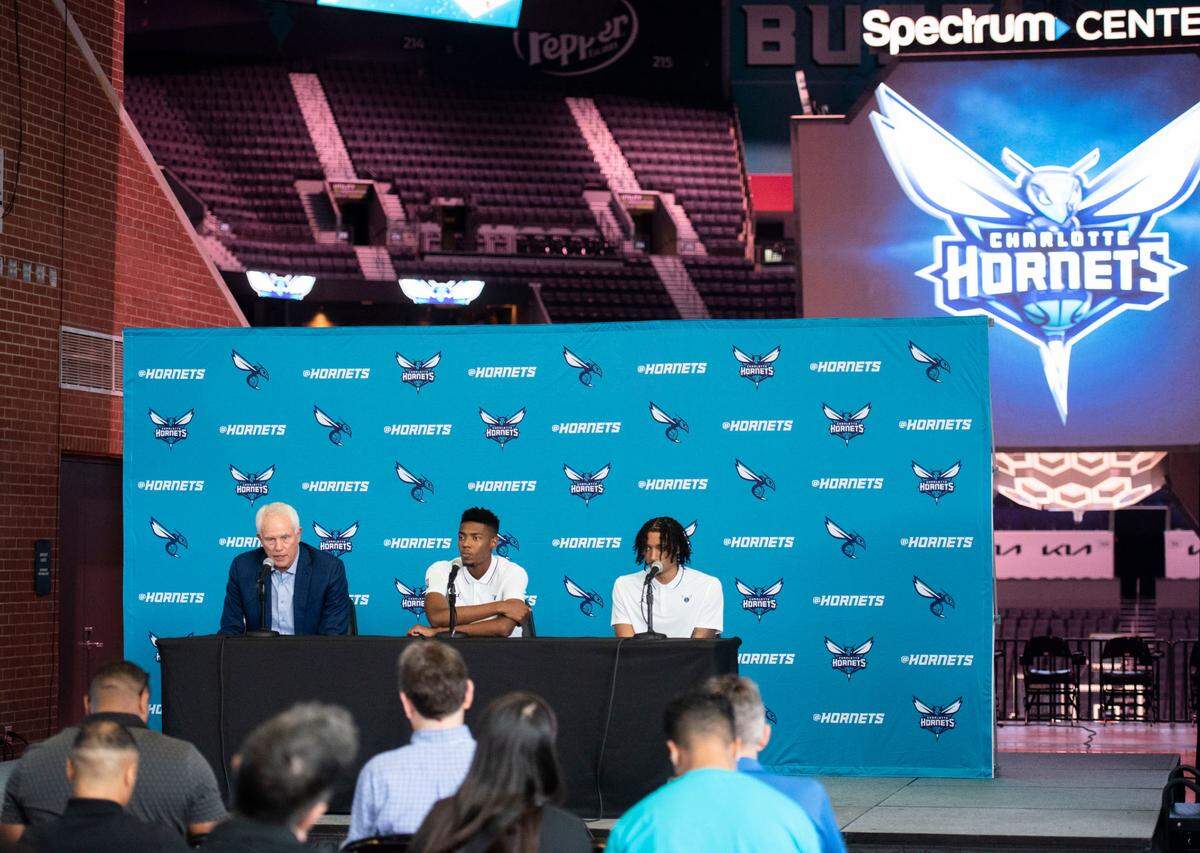 From left to right, Charlotte Hornets General Manager Mitch Kupchak, Brandon Miller and Amari Bailey, newly drafted to the team, field questions during a press conference focused at Spectrum Center on Friday, June 23, 2023.