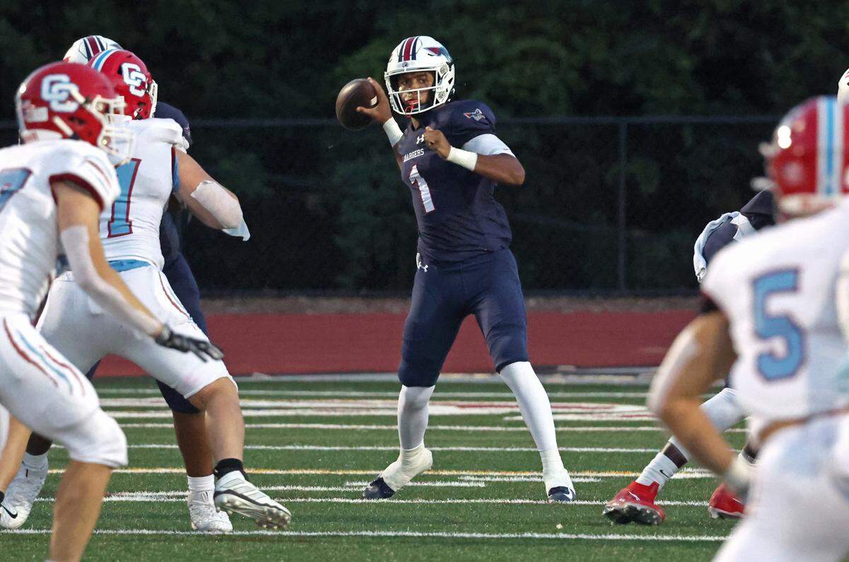 Providence Day quarterback Jadyn Davis, center, drops back to pass to a receiver during first half action against Charlotte Catholic on Friday, September 1, 2023 at Providence Day School.