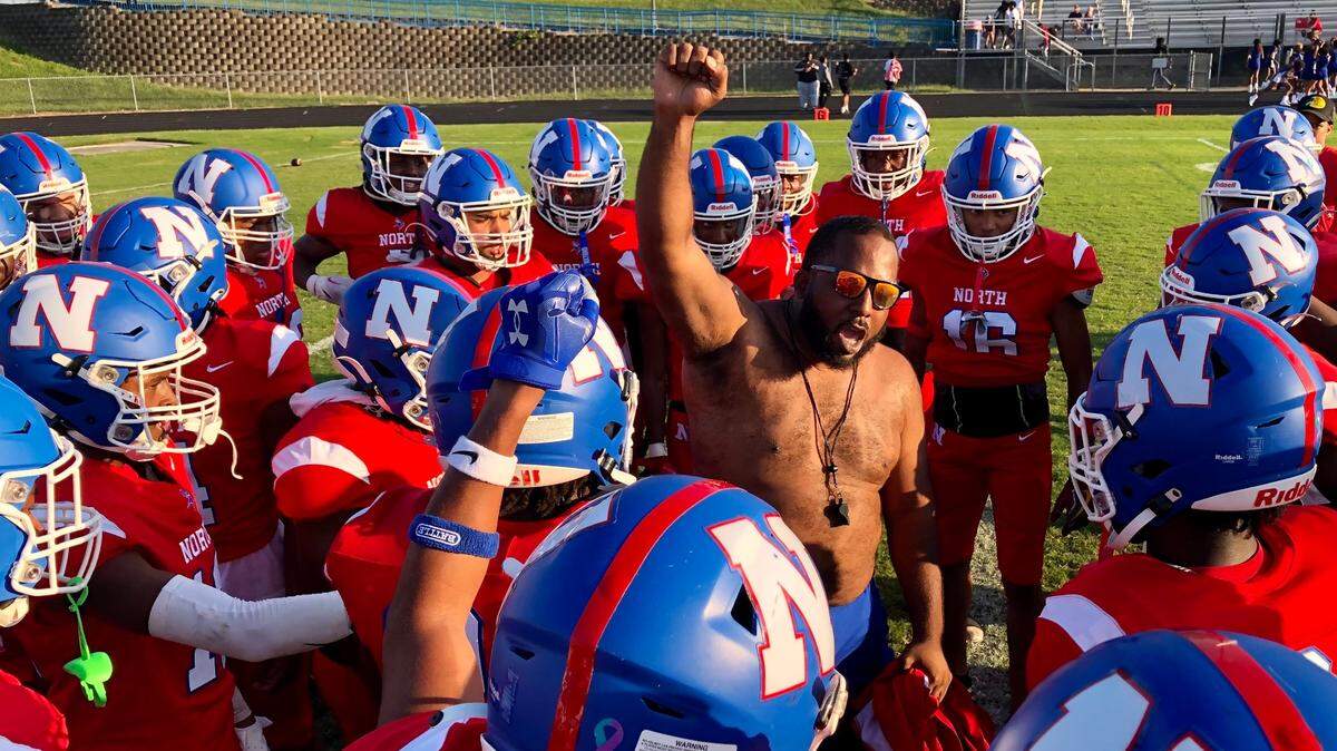 A North Meck coach fires up the team following a series of pre-game drills on Thursday, September 14, 2023. North Meck hosts Hough in prep action. Jeff Siner/The Charlotte Observer
