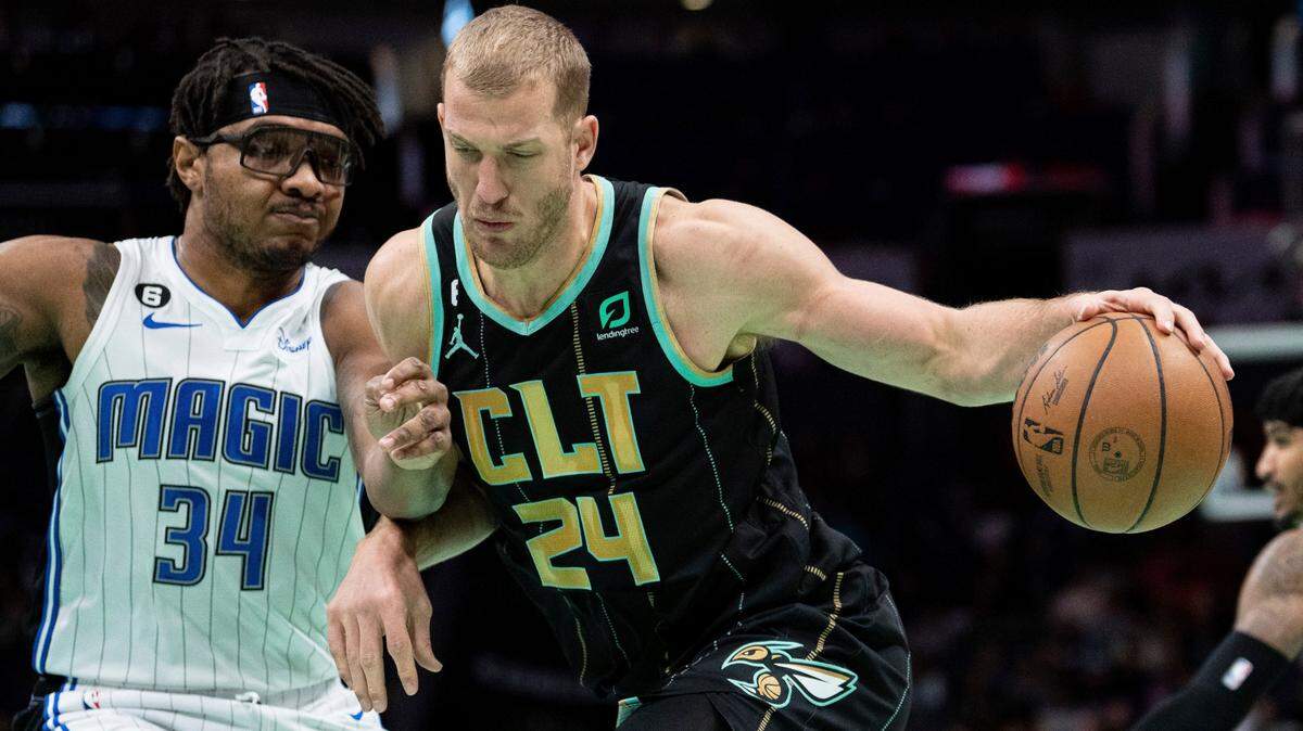 Orlando Magic center Wendell Carter Jr. (34) guards Charlotte Hornets center Mason Plumlee (24) during the first half of an NBA basketball game in Charlotte, N.C., Sunday, Feb. 5, 2023. (AP Photo/Jacob Kupferman)
