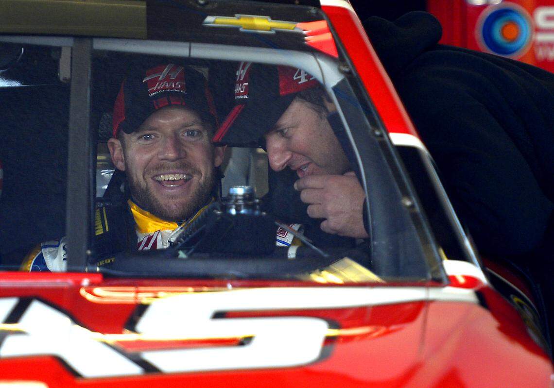 NASCAR Cup series driver Regan Smith jokes with a crew member before leaving the garage to begin practice at Daytona International Speedway on Feb. 21, 2015. Smith replaced Kurt Busch in the Daytona 500 after Busch was indefinitely suspended by NASCAR.