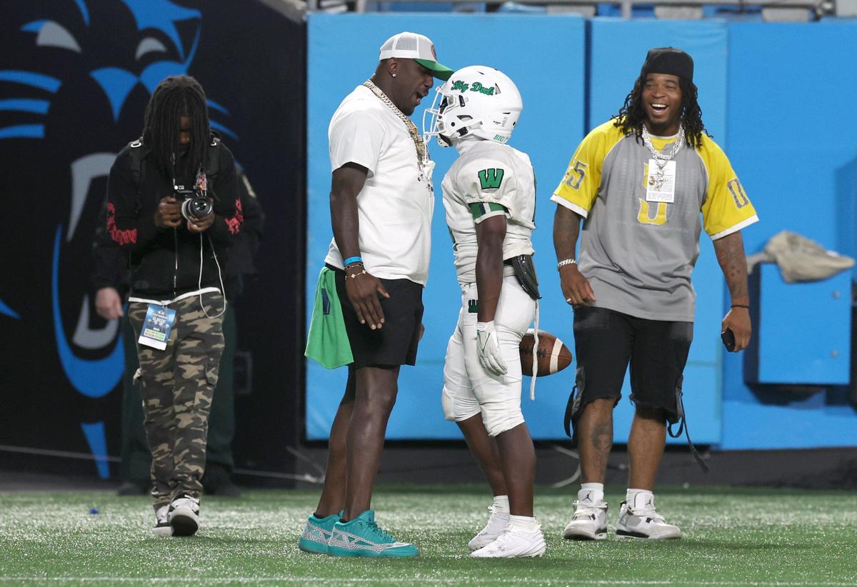 Former Carolina Panthers linebacker Thomas Davis, center/left, celebrates a touchdown with Weddington wide receiver Kelson Tate, right/center, during action against Providence Day on Thursday, August 22, 2024 at Bank of America Stadium in Charlotte, NC. Both teams are competing in the Keep Pounding High School Classic.