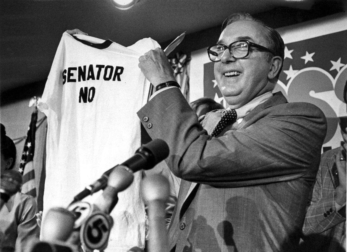 Sen. Jesse Helms, R-N.C., holds up a “Senator No” T-shirt, in Raleigh, N.C., after he was re-elected for a second term in 1978.