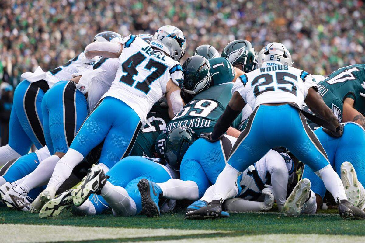 Dec 8, 2024; Philadelphia, Pennsylvania, USA;  Philadelphia Eagles quarterback Jalen Hurts (1) scores during the second quarter against the Carolina Panthers at Lincoln Financial Field. Mandatory Credit: Bill Streicher-Imagn Images