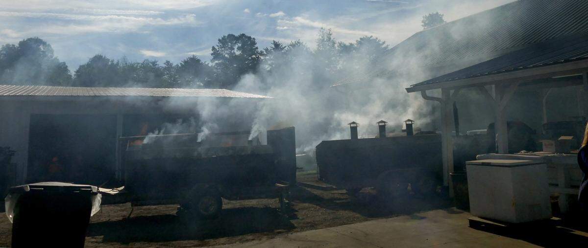 Smoke from the cookers permeates the air as volunteers began preparations for the 88th annual Mallard Creek BBQ at Mallard Creek Presbyterian Church Thursday, October 19, 2017.