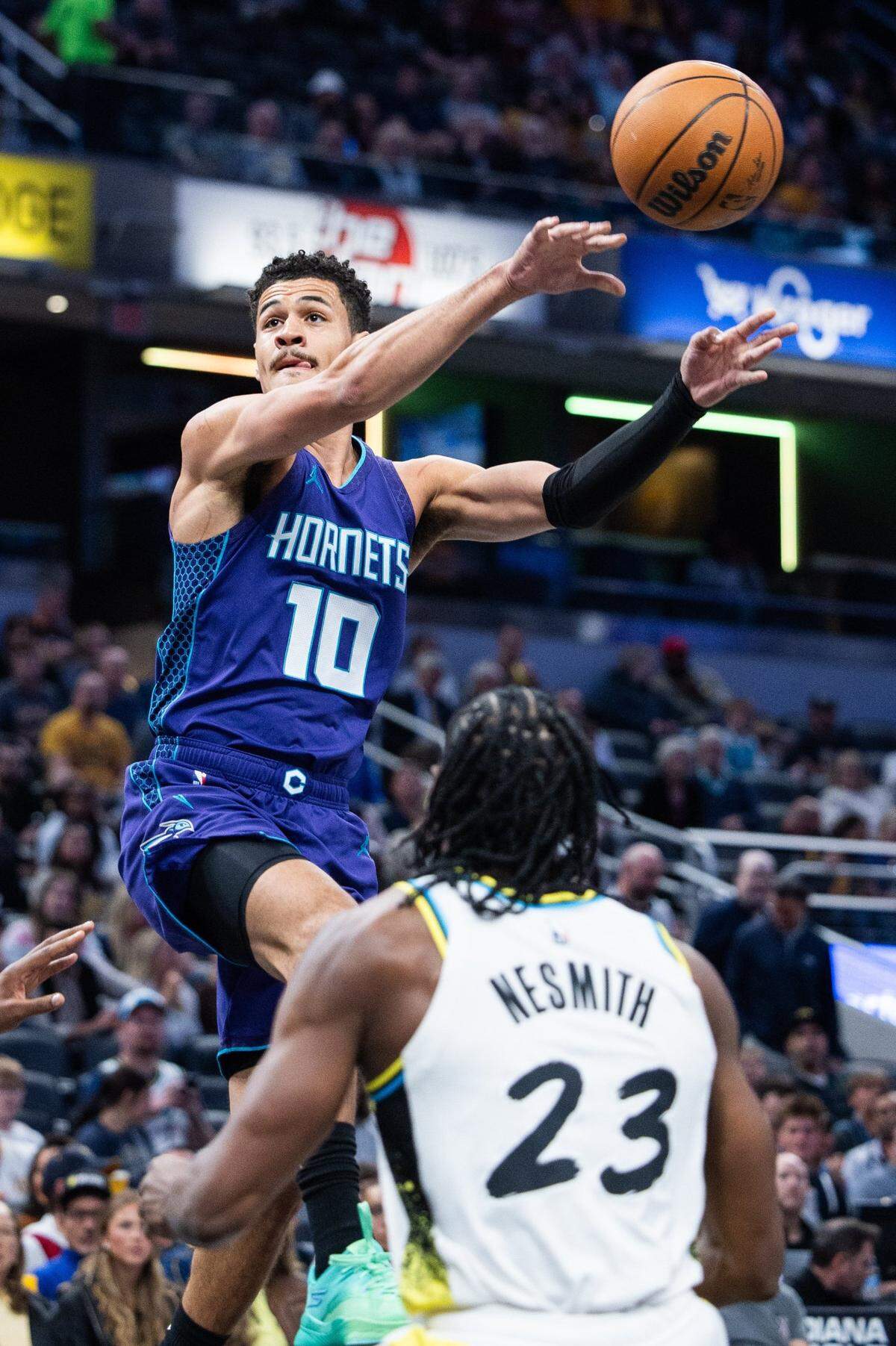 Charlotte Hornets guard Josh Green (10) passes the ball while Indiana Pacers forward Aaron Nesmith (23) defends in the first half at Gainbridge Fieldhouse.