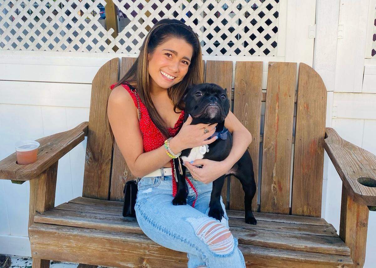 Ivy Coffman and Sir Charles moved to Charlotte less than a year ago and the two “have been taking full advantage of all the pet friendly activities Charlotte has to offer.” The two smile for the camera at the Dog Bar in NoDa.