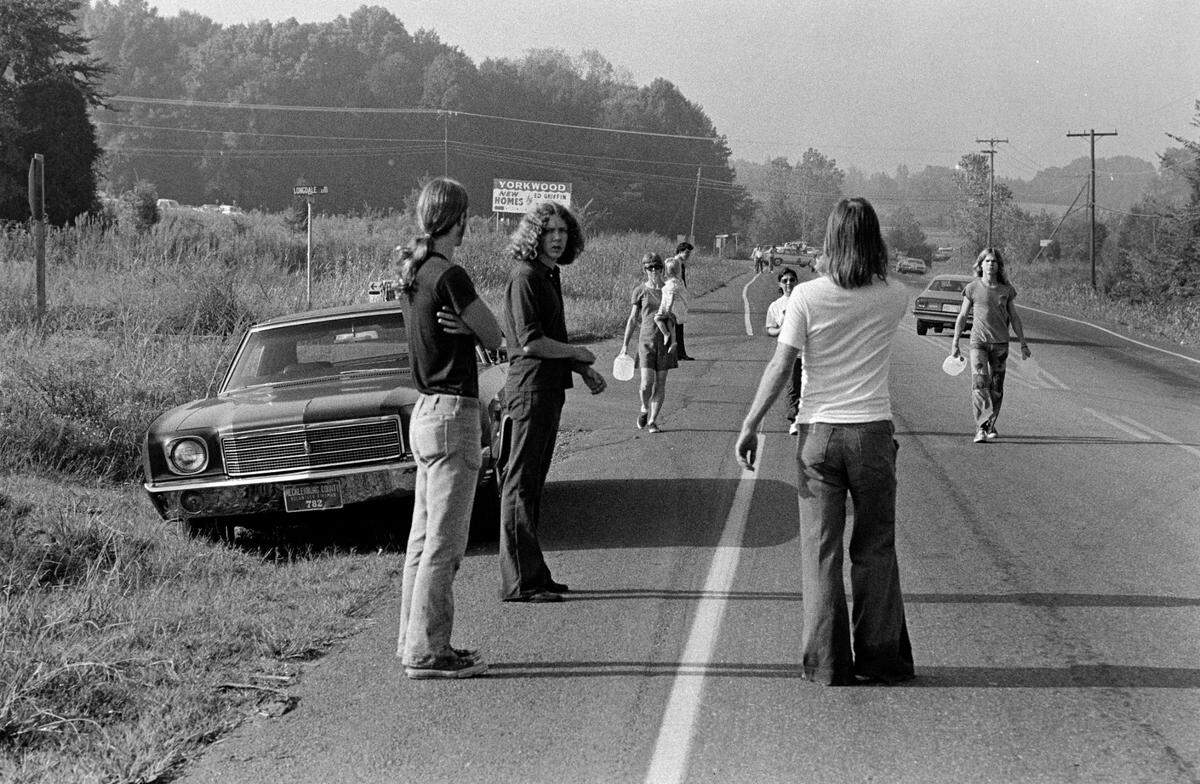 Bystanders gather on Highway 49, near the crash site.