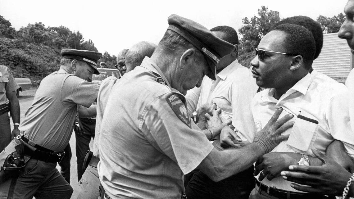 Dr. Martin Luther King Jr. being shoved by a Mississippi patrolman during the March Against Fear, June 8, 1966.
