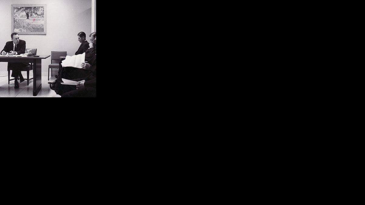 Wallace Kuralt (left) speaks to the Mecklenburg County Welfare board on May 9, 1962 in this Charlotte Observer file photo.
