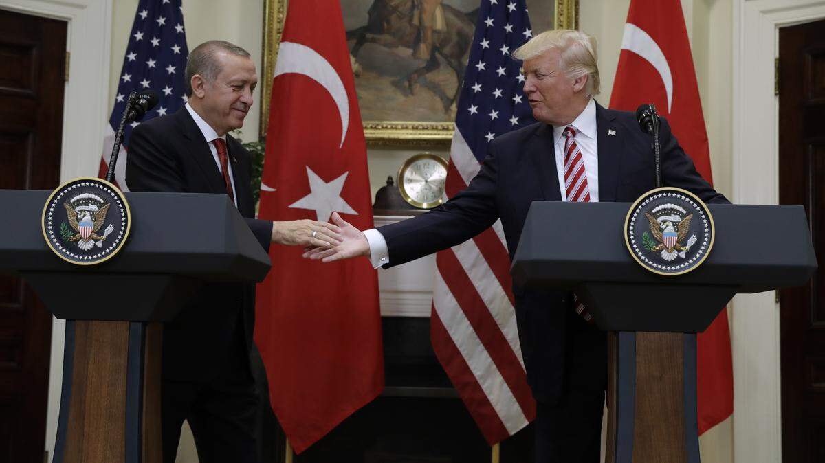 President Donald Trump reaches to shake hands with Turkish President Recep Tayyip Erdogan in the Roosevelt Room of the White House in Washington on May 16, 2017.