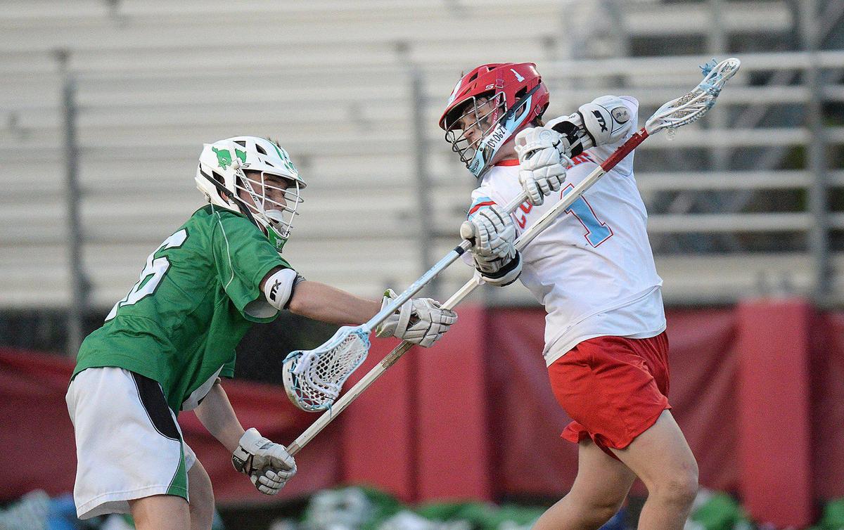 Charlotte Catholic’s #`1, Jack Ransom, scores a first half goal with an over-the-shoulder shot. Charlotte Catholic, ranked #1 in North Carolina and #3 nationally put a perfect, 13-0 record, on the line against 6-3 Myers Park for a match of boys lacrosse teams. The teams were tied 9-9 after the first half. Catholic’s Jack Ransom, a Georgetown recruit, is a standout player. The teams battled on Monday, April 8, 2024.