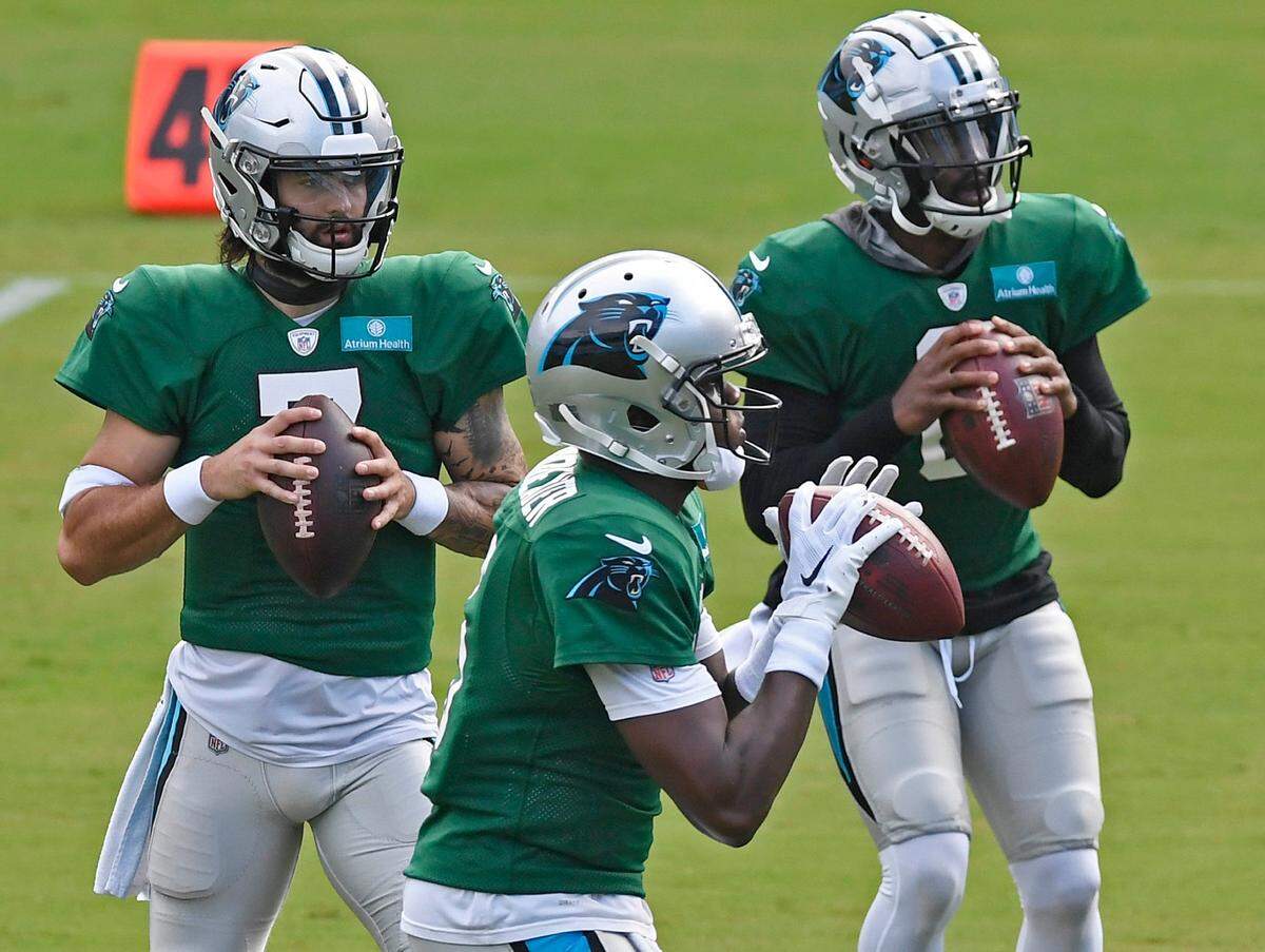 Carolina Panthers quarterback Teddy Bridgewater (5), front, quarterback Will Grier (7), left, and quarterback P.J. Walker (6) drop back to pass during practice at Bank of America Stadium during training camp on Saturday, August 22, 2020.