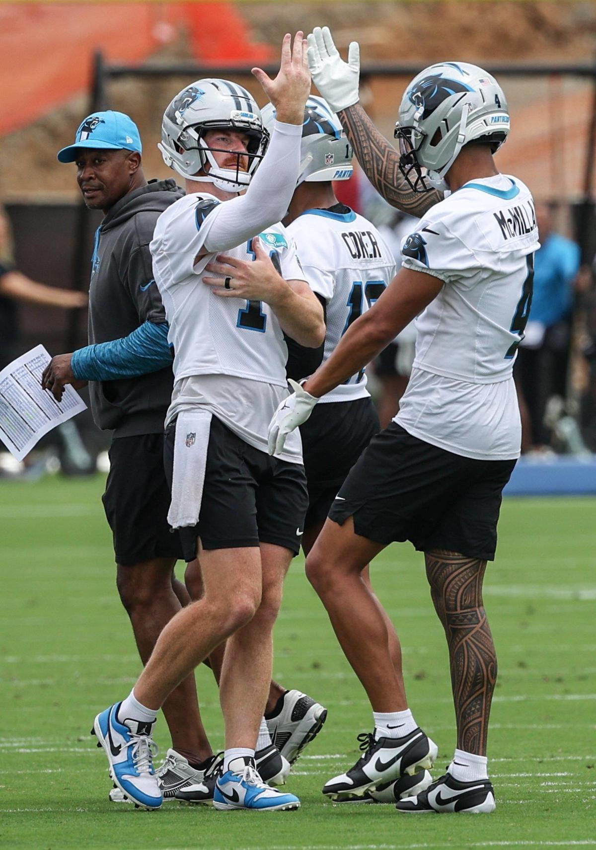 Panthers quarterback Andy Dalton, left, does a special handshake with wide receiver Tetairoa McMillan before they run through passing drills during the first day of minicamp in Charlotte, NC on Tuesday, June 10, 2025.