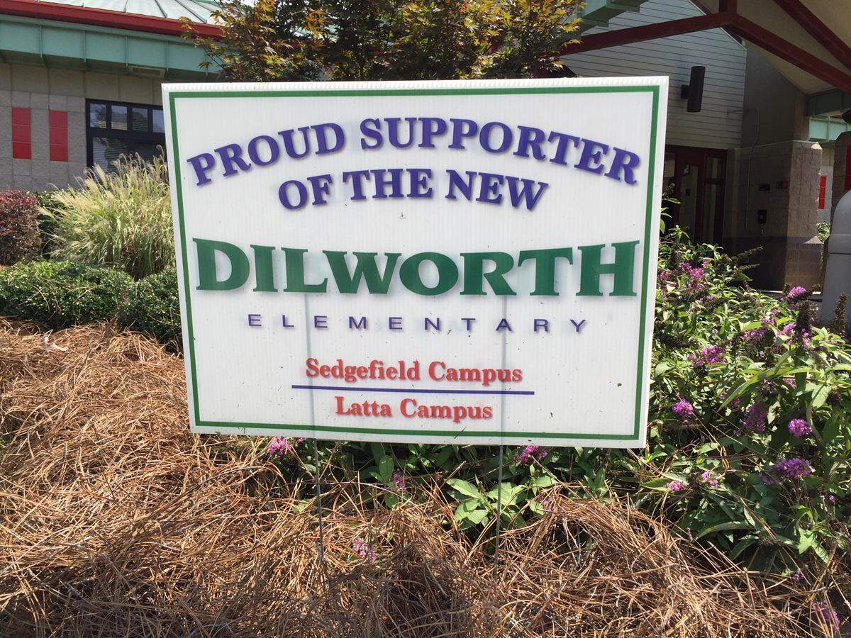 Yard signs proclaim support for the new two-campus version of Dilworth Elementary.