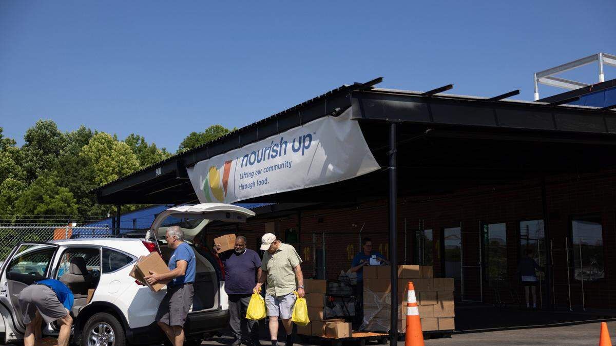 Volunteers pack food to be delivered into a car at the new Nourish Up warehouse in Charlotte on Tuesday, June 11, 2024. The Tepper Foundation is donating $3 million to Nourish Up.