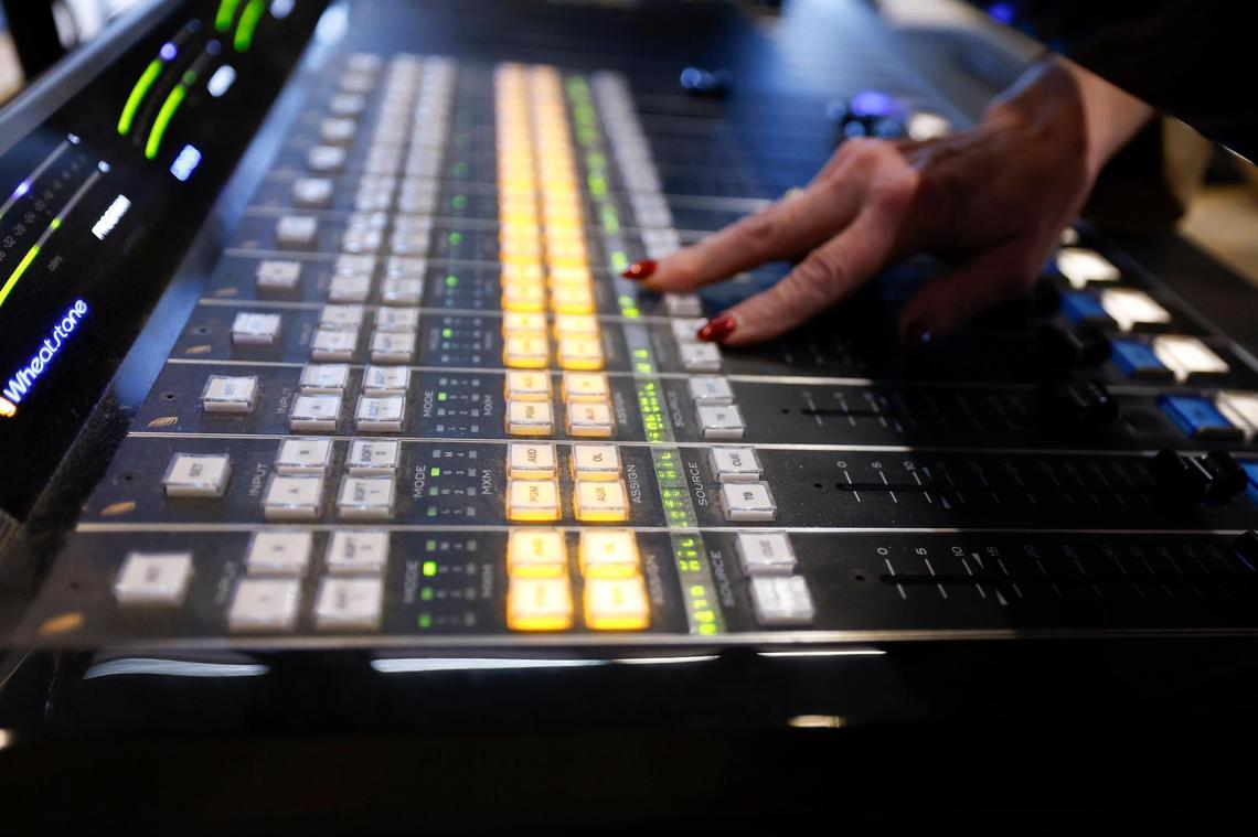 Announcer and associate producer Myelita Melton shows off the soundboard in the Connor On-Air Control Room at WDAV.