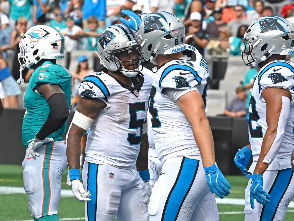 Carolina Panthers running back Rico Dowdle, center, is congratulated by his teammates after he rushed for a touchdown during fourth quarter action against the Miami Dolphins on Sunday, October 5, 2025 at Bank of America Stadium in Charlotte, NC. The Panthers defeated the Dolphins 27-24.