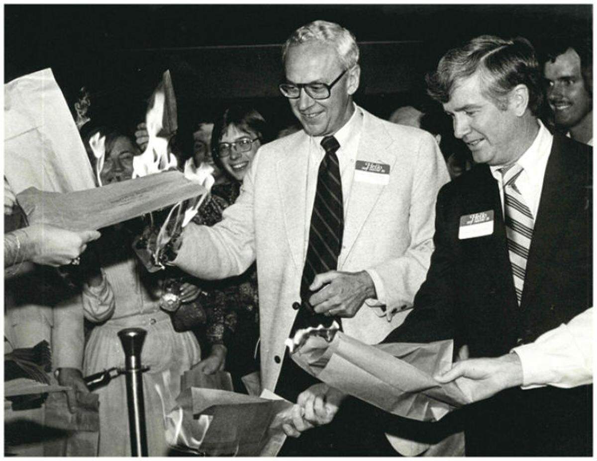 Bill Hensley, who advocated for “liquor by the drink” sales, burns a brown bag - associated with “brown bag laws” - alongside state Rep. Ben Tison in 1978.