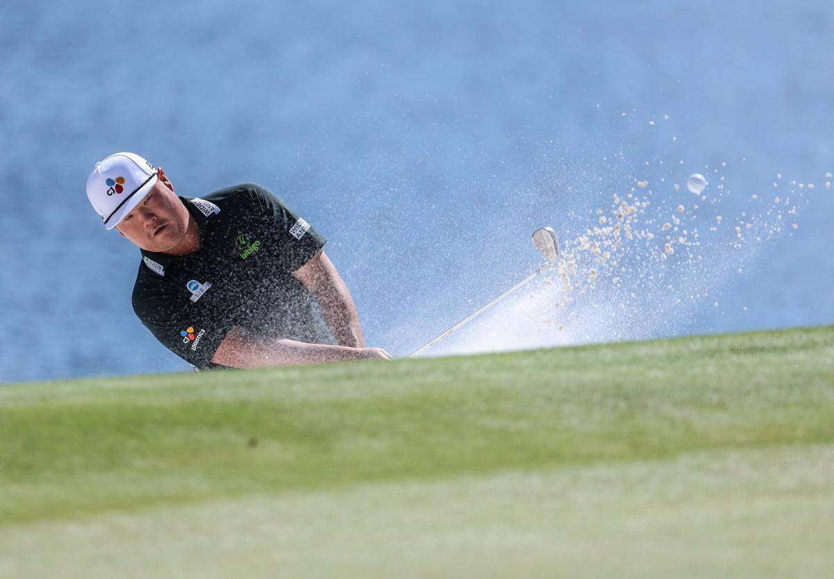 Sungjae Im hits from a bunker on the 14th hole during round three of the Wells Fargo Championship at Quail Hollow Club in Charlotte, N.C., on Saturday, May 11, 2024.