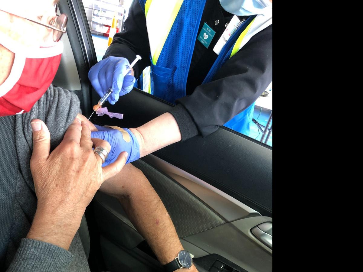 Observer reporter Michael Gordon gets his COVID-19 vaccination Friday at Atrium Health’s vaccination clinic at Charlotte Motor Speedway. Photo courtesy of Jennifer Halls.