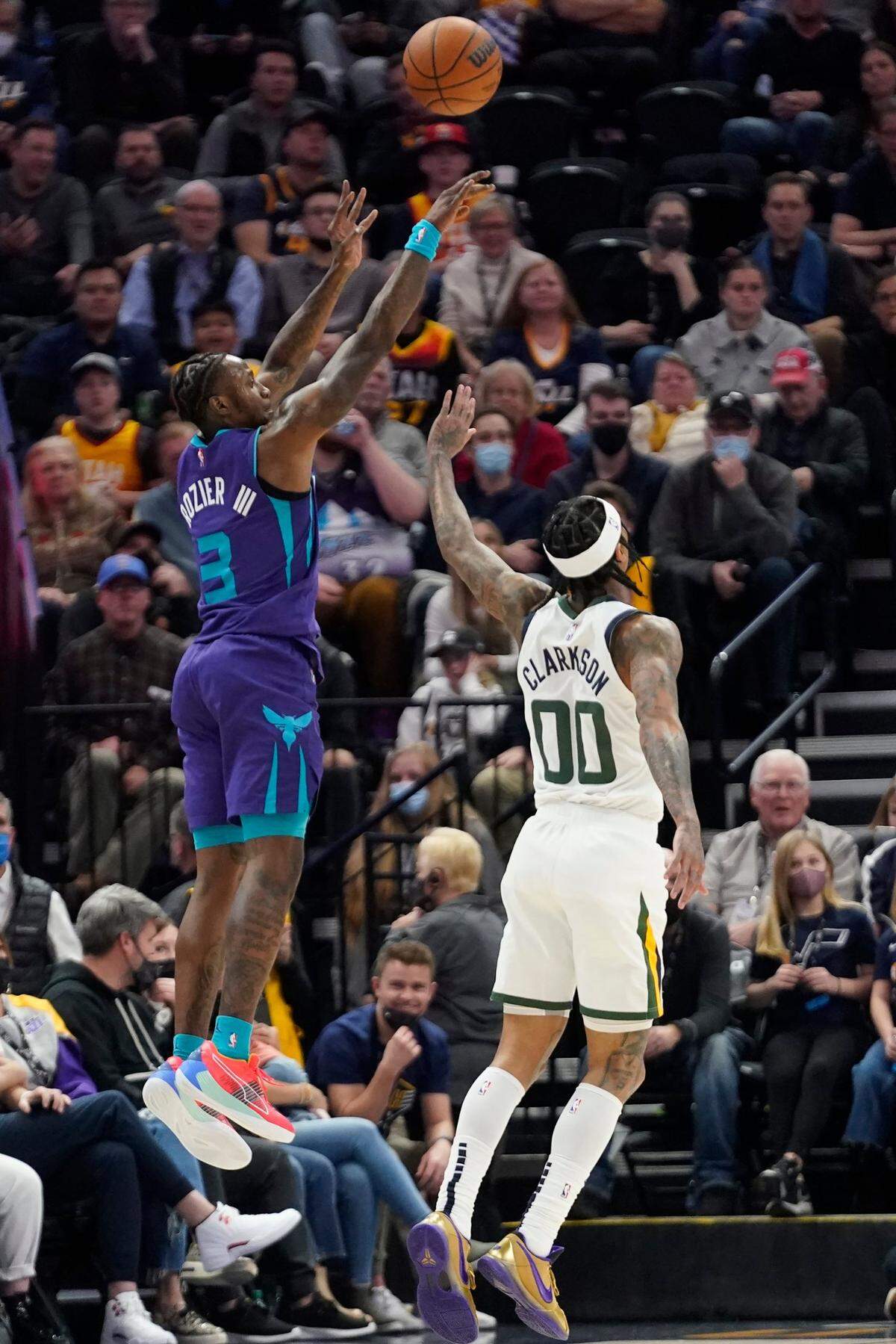 Charlotte Hornets guard Terry Rozier (3) shoots as Utah Jazz guard Jordan Clarkson (00) defends in the second half during an NBA basketball game Monday, Dec. 20, 2021, in Salt Lake City. (AP Photo/Rick Bowmer)