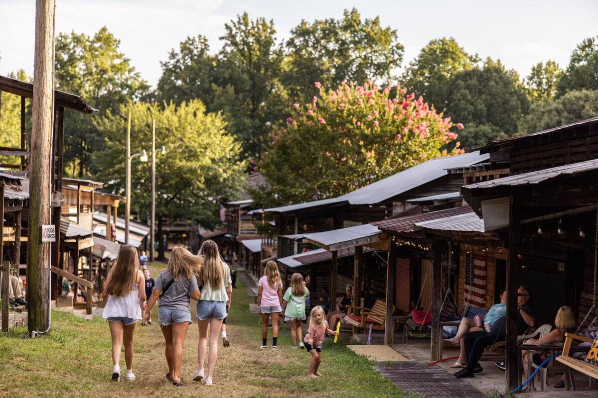 Families walk around in the evening at Rock Springs Camp Meeting in Denver, N.C., on Friday, August 10, 2023.