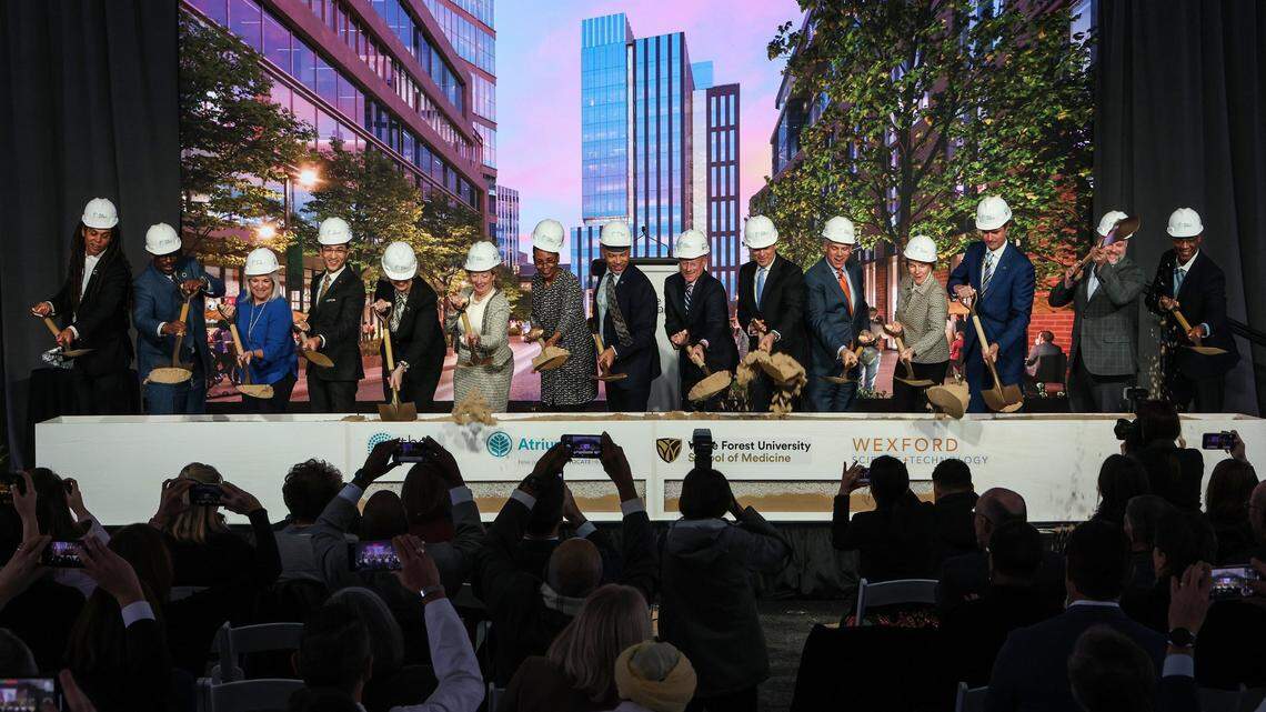 Officials and speakers toss dirt at the groundbreaking ceremony for Wake Forest University School of Medicine Charlotte and “The Pearl” Innovation District on Tuesday, January 17, 2023.