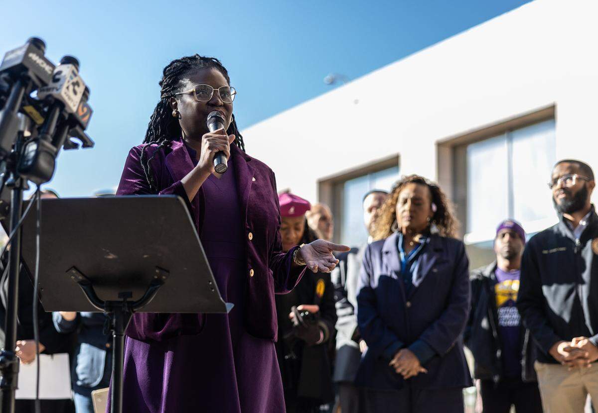 Representative Aisha Dew speaks during the news conference with local and state leaders.