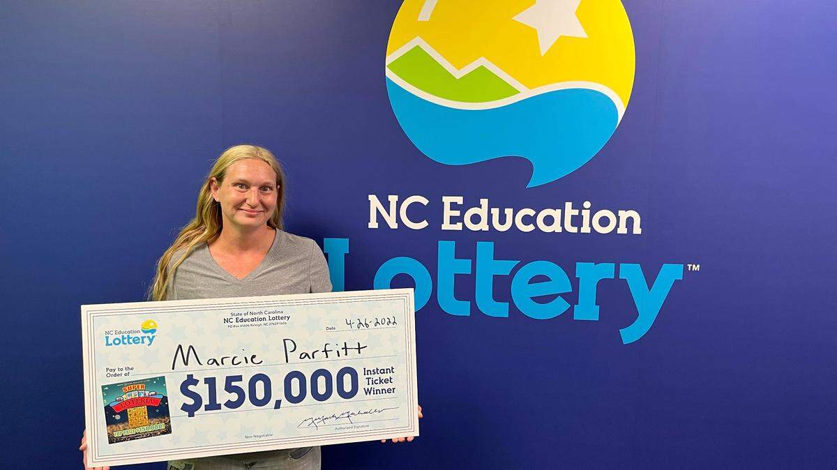 Marcie Parfitt, 38, couldn’t stop smiling after she won the $150,000 Super Loteria grand prize. She collected her prize at lottery headquarters on Tuesday.