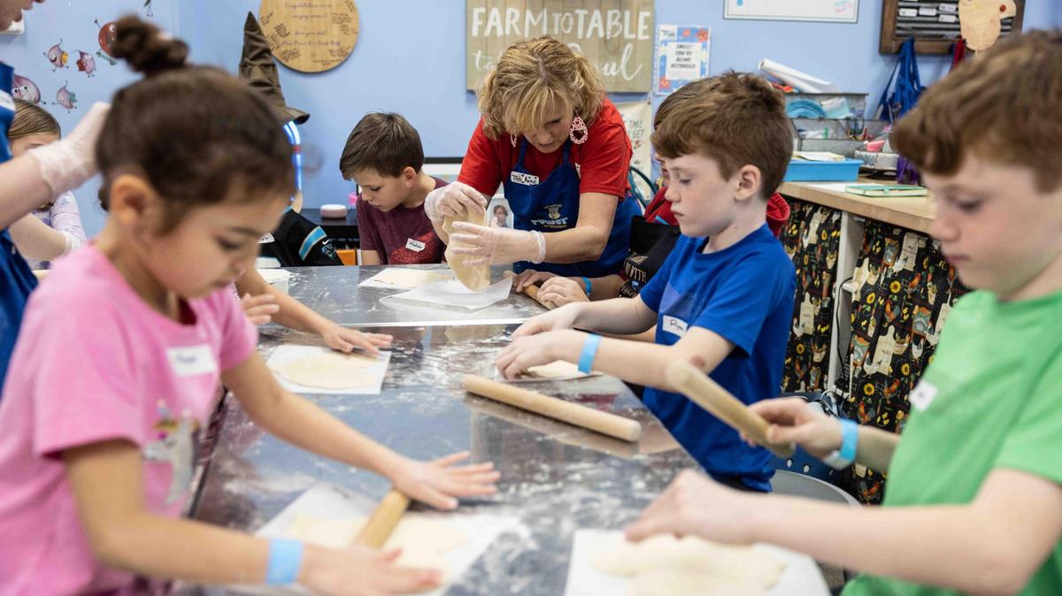 Kids learn to make pizza during a cooking class at Flour Power Kids Cooking Studios.