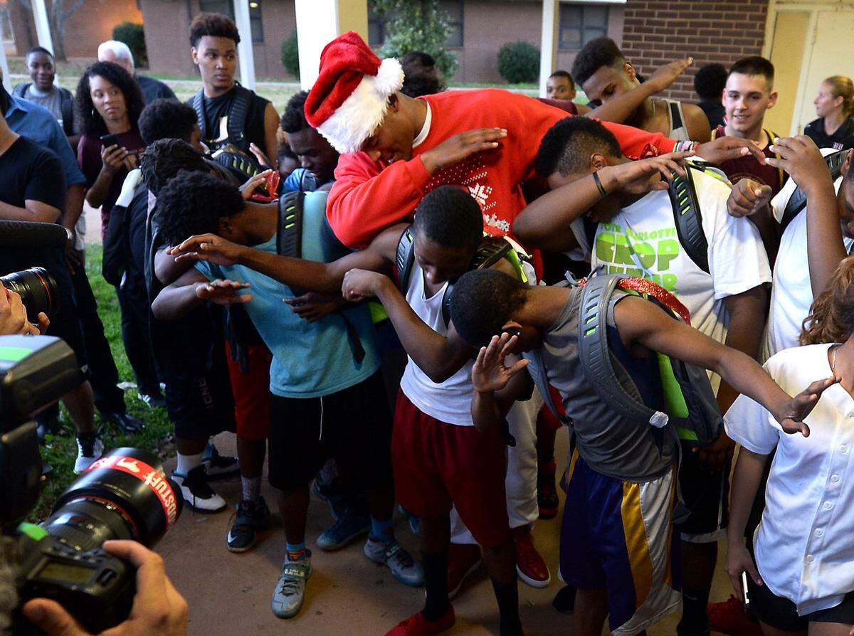 Harding University High School students joined Carolina Panthers quarterback Cam Newton for a dab photo in December 2015.