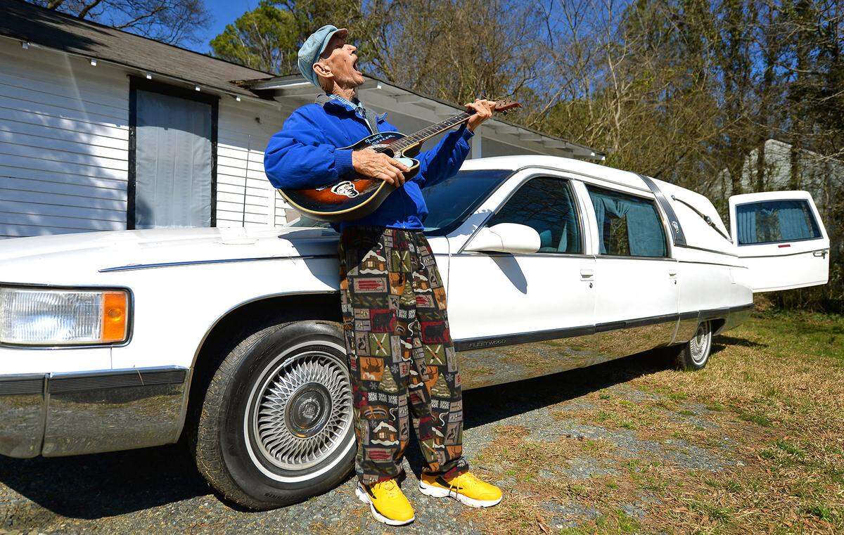 Woody Williams poses with his 1996 Cadillac hearse outside of his home near the Hidden Valley area of Charlotte.