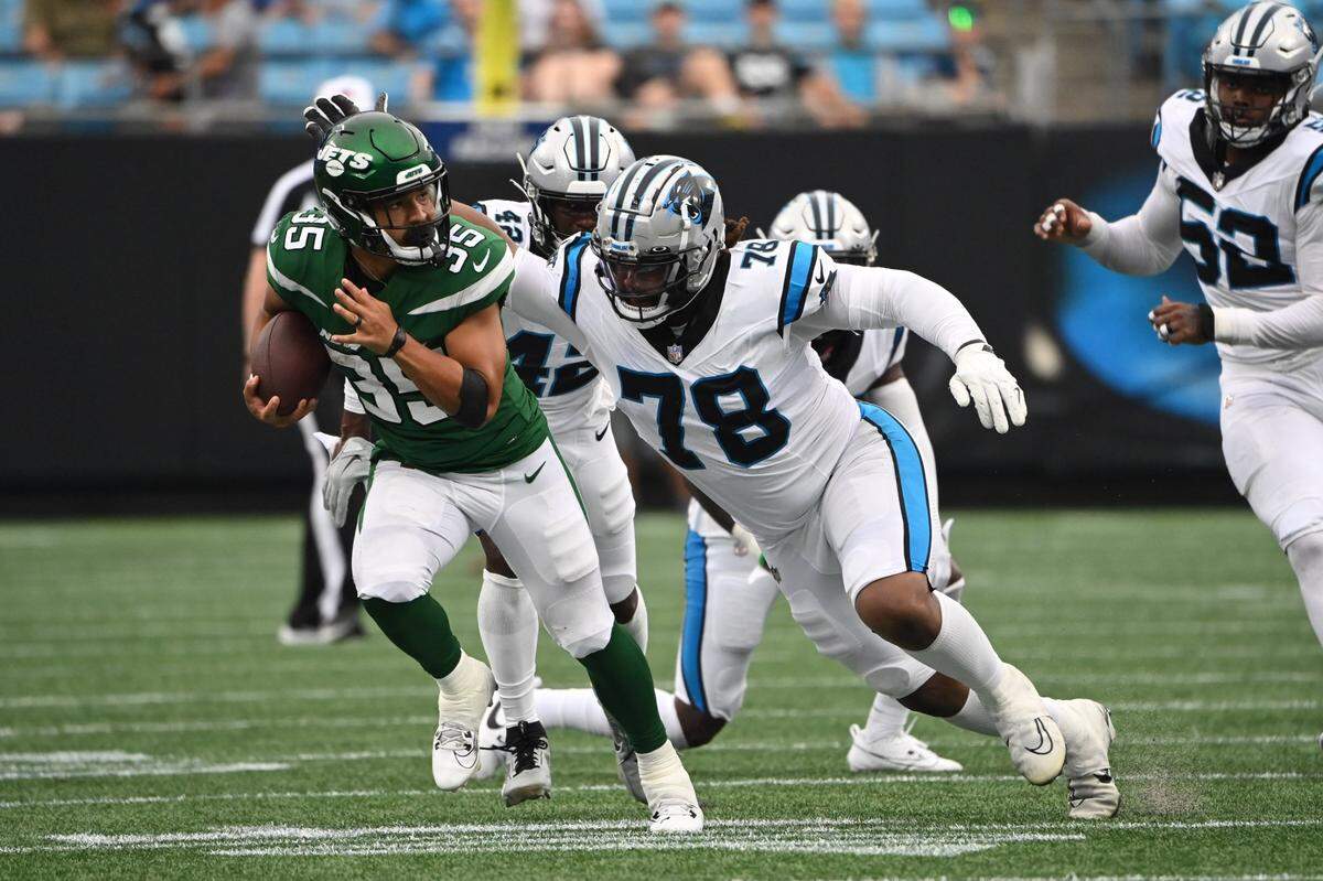Aug 12, 2023; Charlotte, North Carolina, USA; New York Jets running back Travis Dye (35) with the ball as Carolina Panthers defensive tackle Taylor Stallworth (78) defends in the fourth quarter at Bank of America Stadium. Mandatory Credit: Bob Donnan-USA TODAY Sports