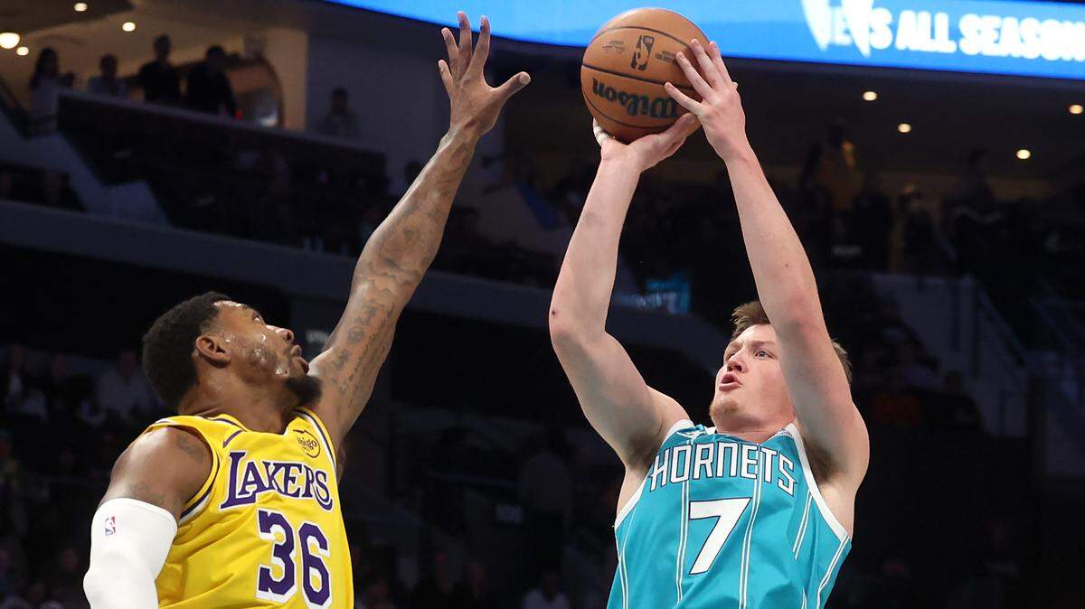 Charlotte Hornets rookie Kon Knueppel (right) releases a jump shot over Los Angeles Lakers guard Marcus Smart Monday. The Lakers won, 121-111, with Knueppel narrowly missing a triple-double (19 points, 10 rebounds, nine assists).