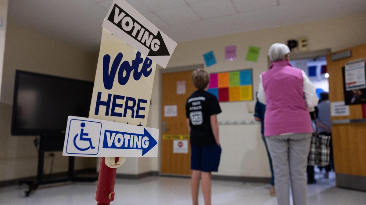Voters wait in line to vote at Myers Park Traditional Elementary School in Charlotte on Tuesday.