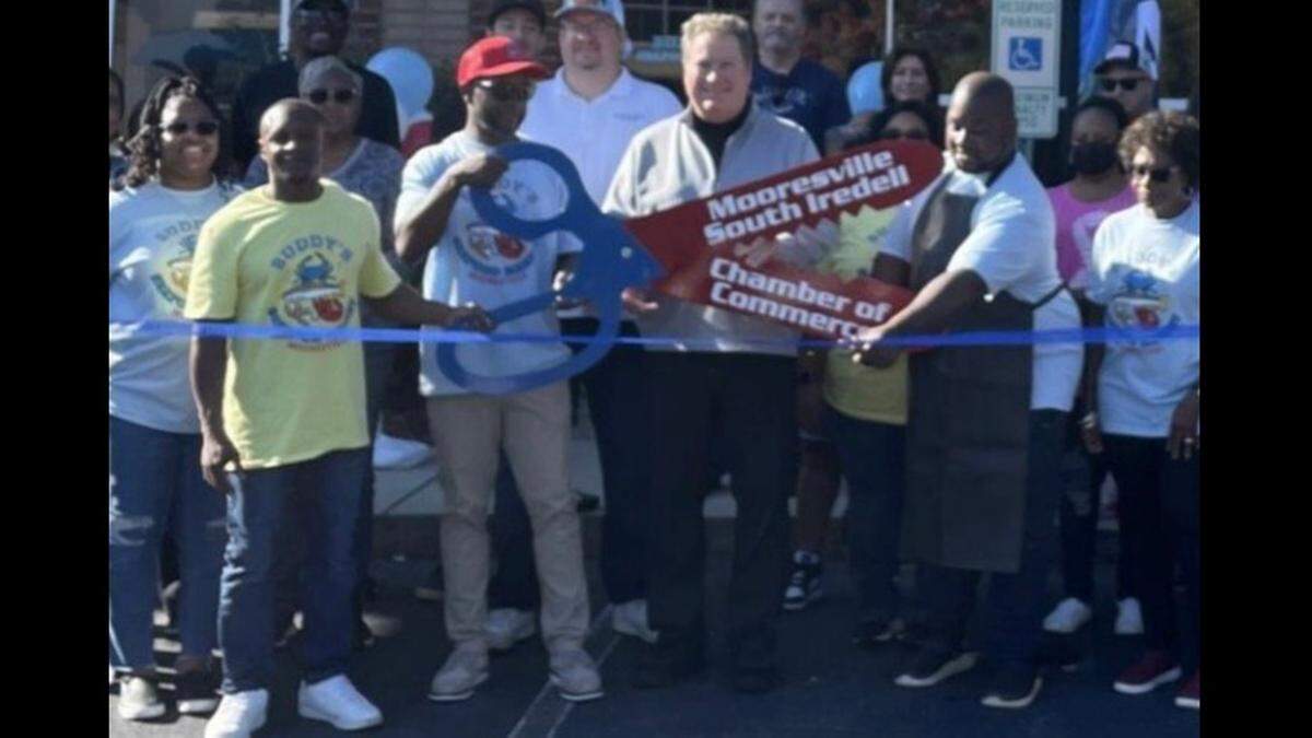 The Mooresville-South Iredell Chamber of Commerce held a ribbon cutting to mark the opening of Buddy’s Seafood Market. Shown, in front at the ribbon, from left, are Jemel Harris; Aviston Harris; Kirk Ballard, chamber president and CEO; and Cornell Harris.