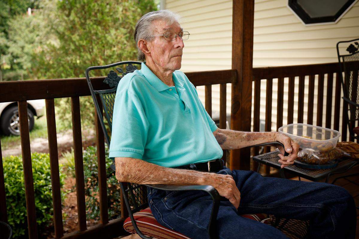 Frank Lowery, sitting on the porch of his home in Anson County, has seen dozens of poultry barns pop up near his home, bringing strong odors, turkey vultures and more truck traffic. “It’s not a good place for me to be right now,” he says.